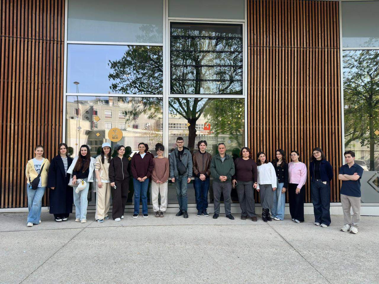 Group photo of CEEP students outside a modern building